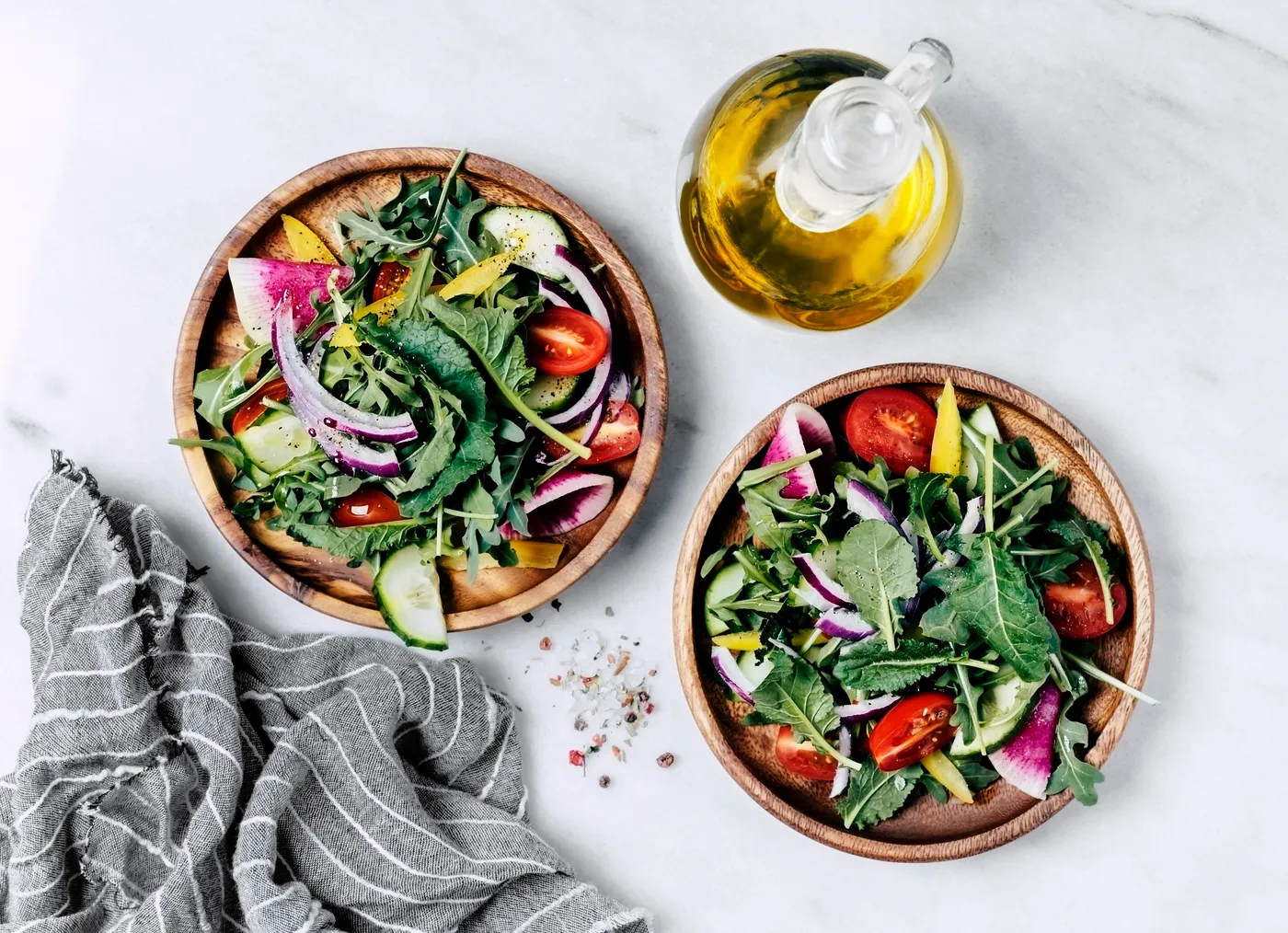 A vibrant, nutrient-dense salad bowl on a bright marble countertop